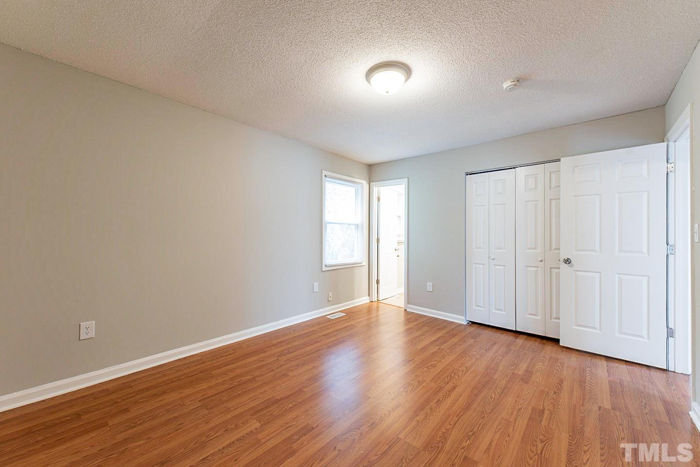 3601 Dixon Road Durham, NC 27707 - Photo 22 of 27 a view of an empty room with wooden floor and a window