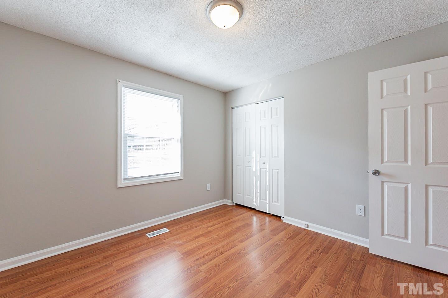 3601 Dixon Road Durham, NC 27707 - Photo 23 of 27 an empty room with wooden floor and windows