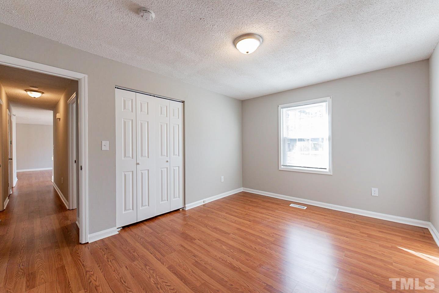 3601 Dixon Road Durham, NC 27707 - Photo 24 of 27 an empty room with wooden floor and windows