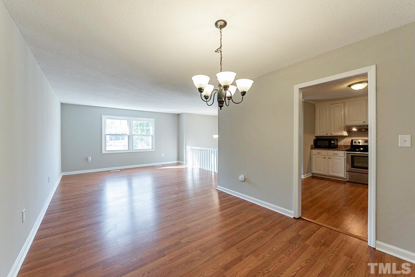 3601 Dixon Road Durham, NC 27707 - Photo 3 of 27 a view of livingroom with chandelier and wooden floor