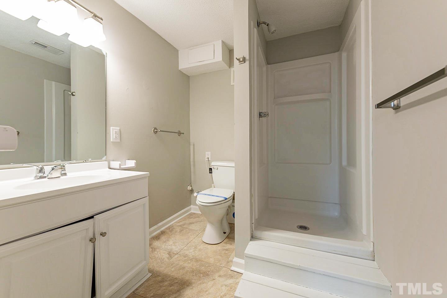 3601 Dixon Road Durham, NC 27707 - Photo 8 of 27 a bathroom with a shower sink vanity and toilet