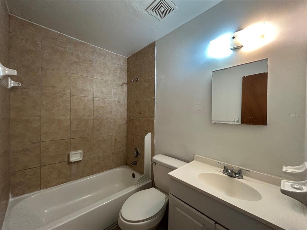 2614 Southwest 31 Place Gainesville, FL 32608 - Photo 11 of 15 a bathroom with a sink a toilet and shower