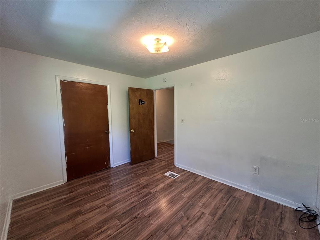 2614 Southwest 31 Place Gainesville, FL 32608 - Photo 14 of 15 a view of an empty room with wooden floor and window