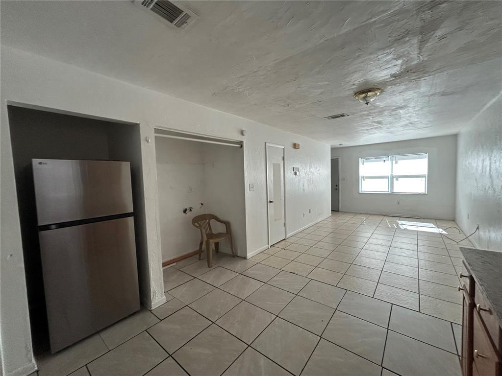2614 Southwest 31 Place Gainesville, FL 32608 - Photo 3 of 15 a view of a refrigerator in kitchen and an empty room