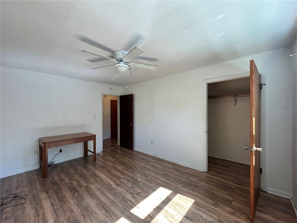 2614 Southwest 31 Place Gainesville, FL 32608 - Photo 8 of 15 wooden floor in an empty room with a window
