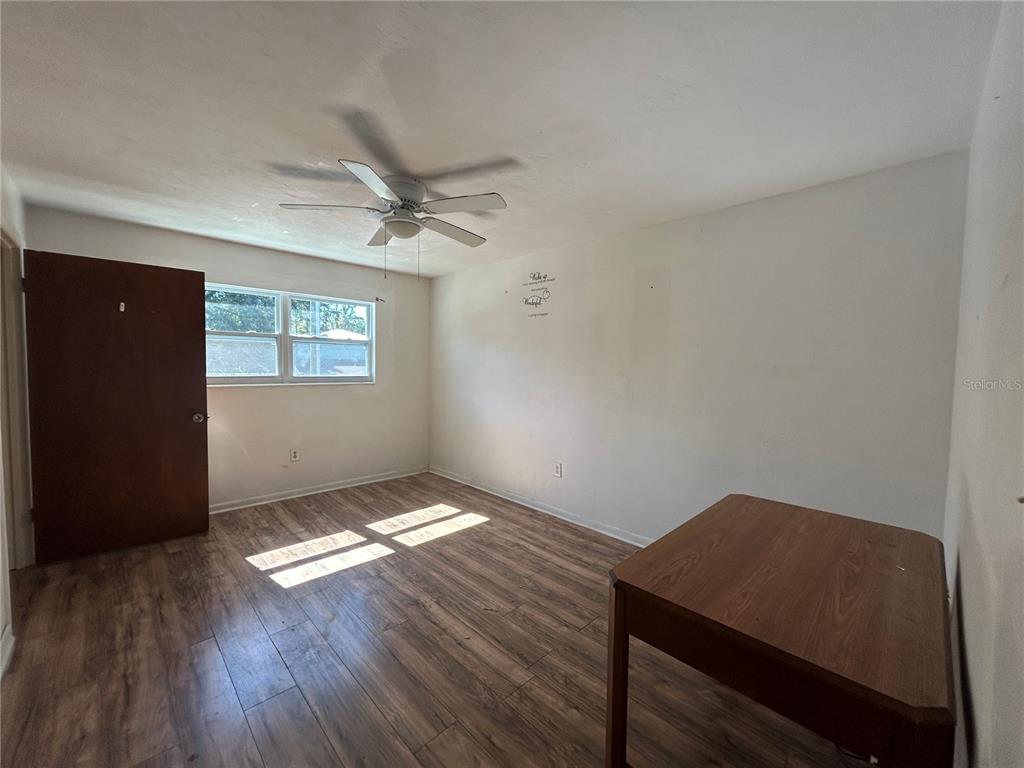 2614 Southwest 31 Place Gainesville, FL 32608 - Photo 10 of 15 a view of an empty room with a window and wooden floor