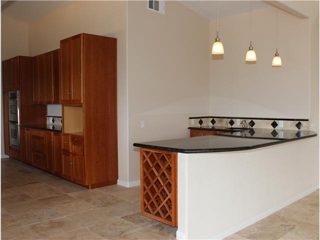 6391 West Lilac Road Bonsall, CA 92003 - Photo 6 of 10 This kitchen is so large it needs two photos! Shown is travertine tile flooring. Modern appliances, wood cabinets, built in wine rack, granite slab counter tops with breakfast bar, second stainless sink, etc.