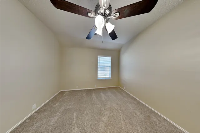 a view of room with window and ceiling fan