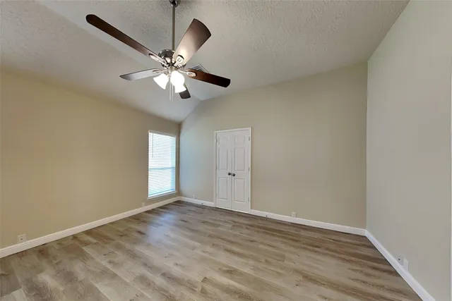 a view of room with window and ceiling fan