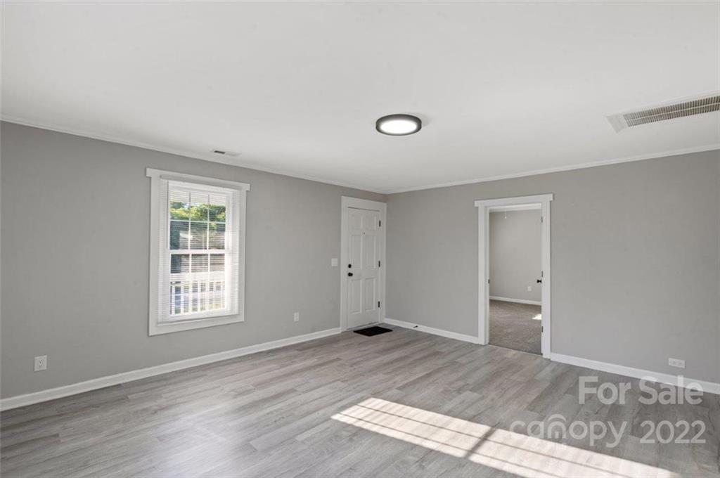413 Modena Street Gastonia, NC 28054 - Photo 11 of 22 a view of empty room with wooden floor and fan