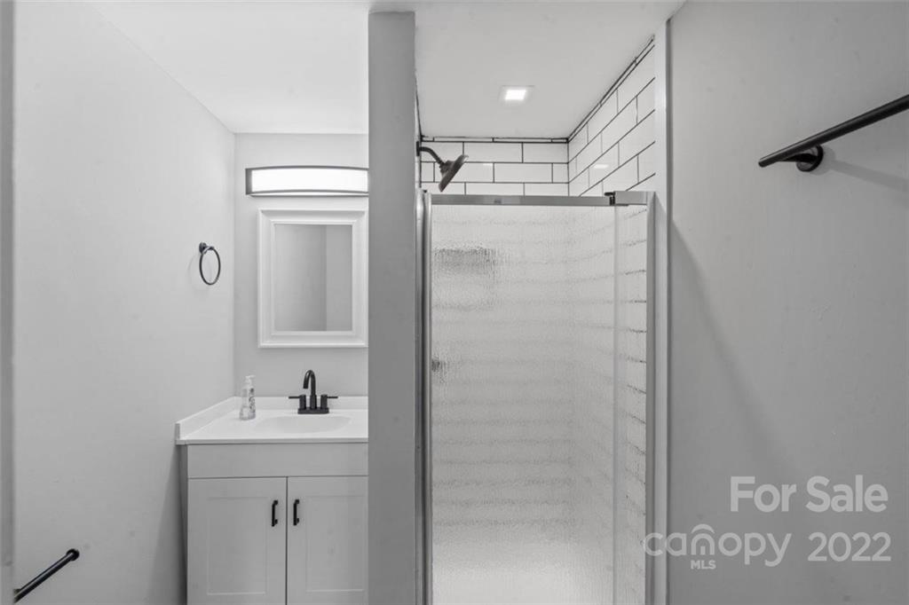 413 Modena Street Gastonia, NC 28054 - Photo 12 of 22 a bathroom with a shower sink and mirror