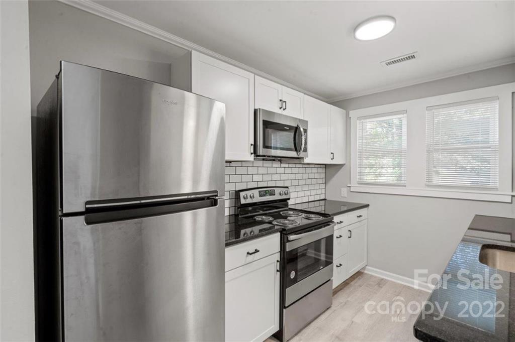 413 Modena Street Gastonia, NC 28054 - Photo 16 of 22 a kitchen with stainless steel appliances a refrigerator stove and microwave