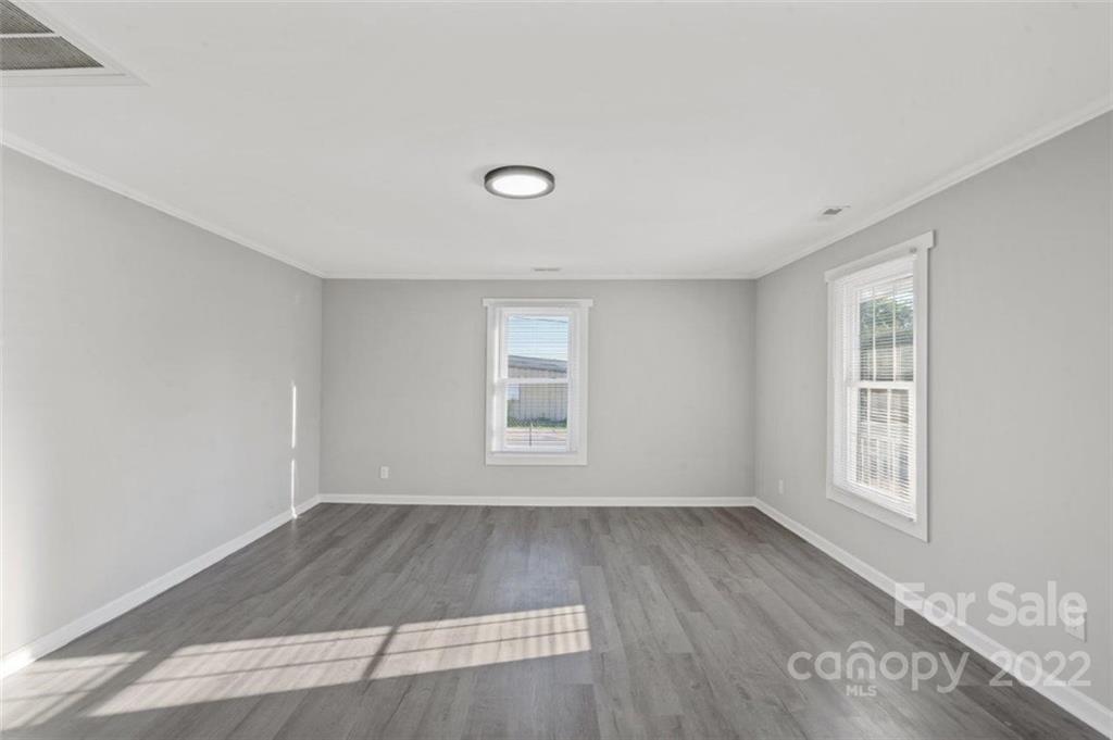 413 Modena Street Gastonia, NC 28054 - Photo 9 of 22 an empty room with wooden floor and windows