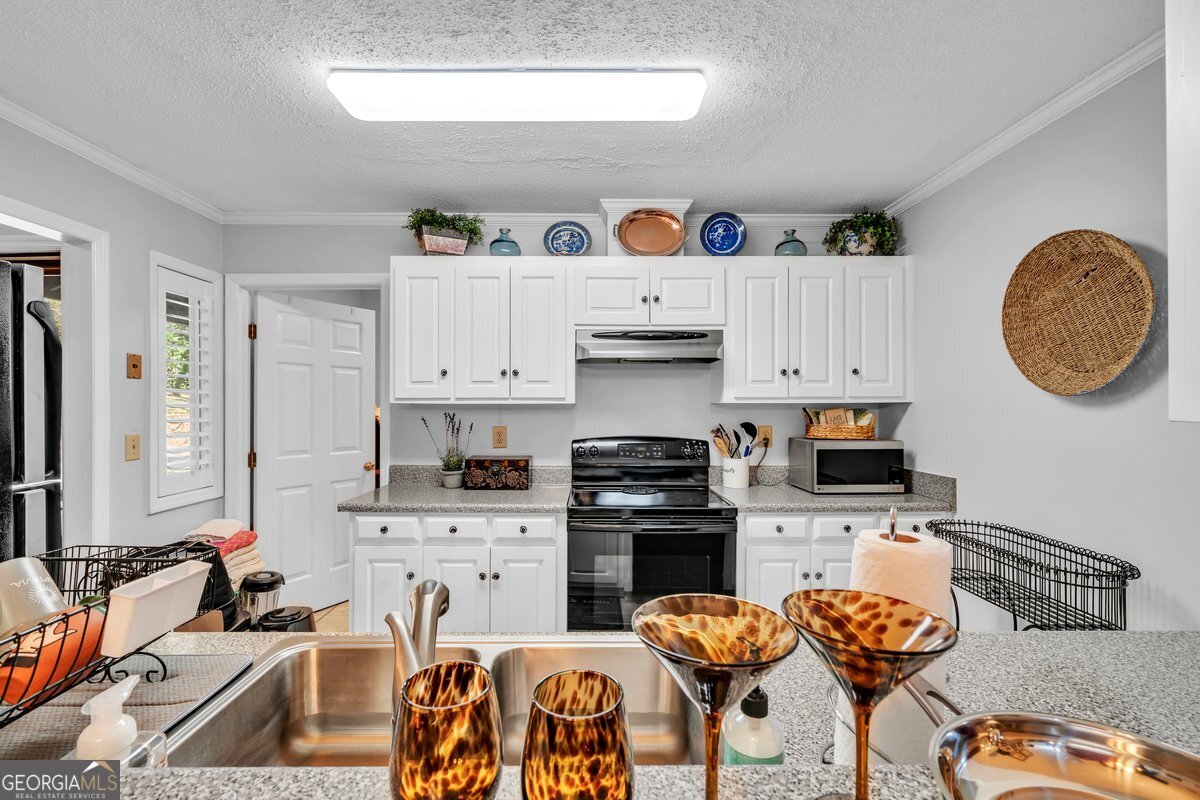 254 Valhalla Road South, Unit F Cordele, GA 31015 - Photo 15 of 41 a kitchen with stainless steel appliances granite countertop a stove and a sink