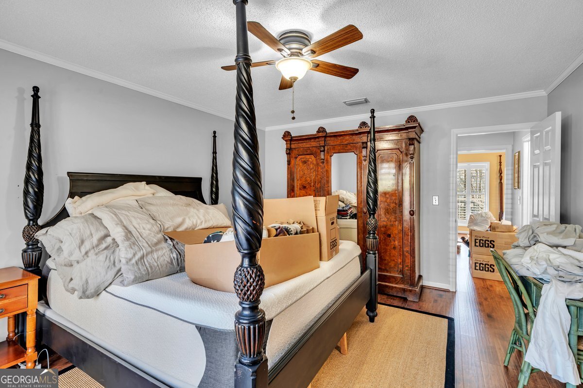 254 Valhalla Road South, Unit F Cordele, GA 31015 - Photo 18 of 41 a bedroom with furniture and a chandelier