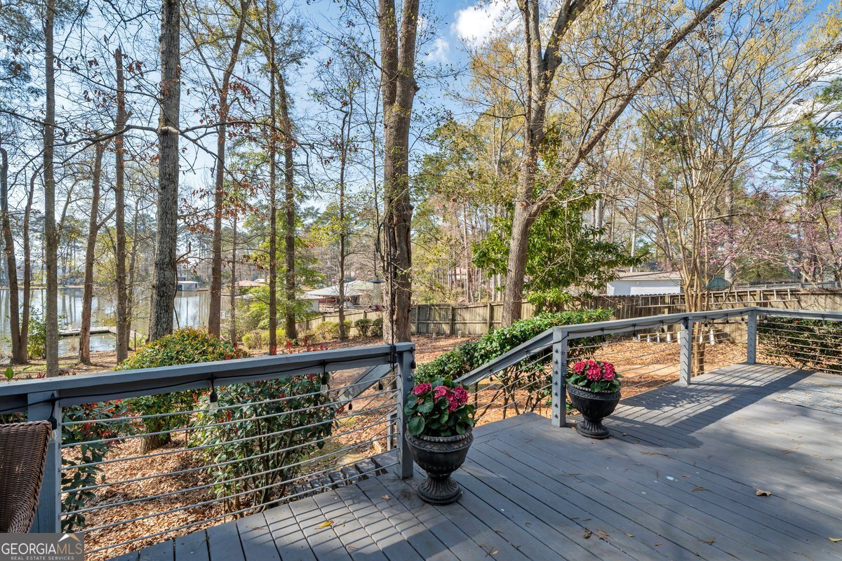 254 Valhalla Road South, Unit F Cordele, GA 31015 - Photo 2 of 41 a view of a balcony with wooden floor and fence