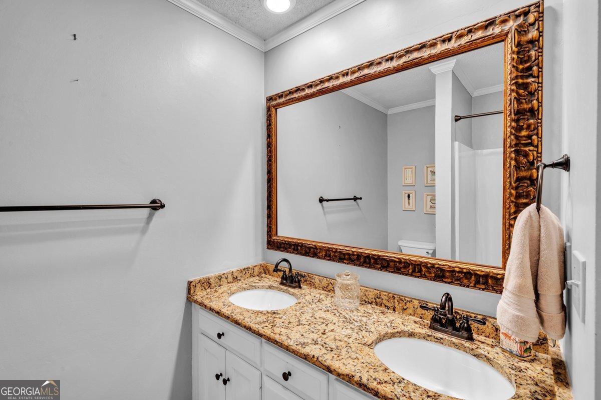 254 Valhalla Road South, Unit F Cordele, GA 31015 - Photo 21 of 41 a bathroom with a granite countertop sink and a mirror