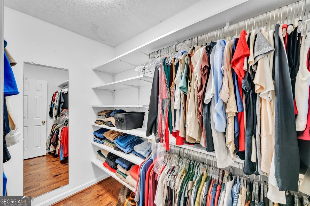 254 Valhalla Road South, Unit F Cordele, GA 31015 - Photo 22 of 41 a view of walk in closet with clothes