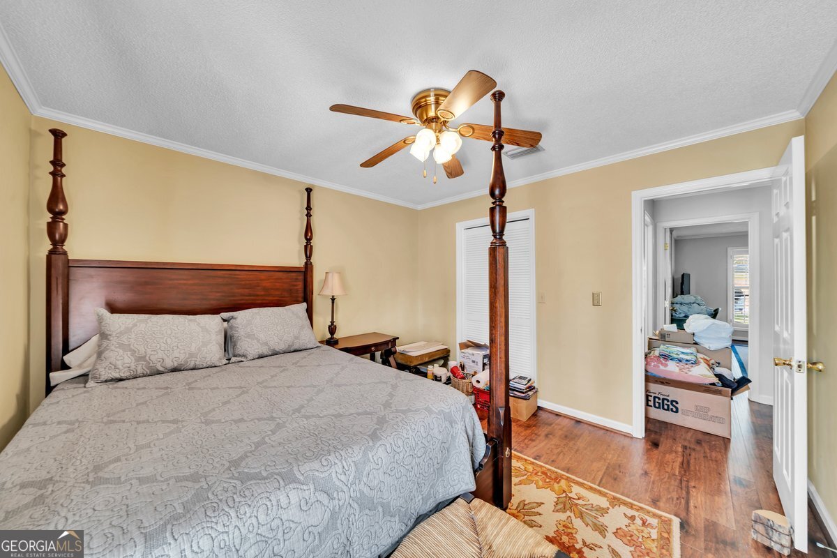 254 Valhalla Road South, Unit F Cordele, GA 31015 - Photo 23 of 41 a bedroom with a bed and a mirror