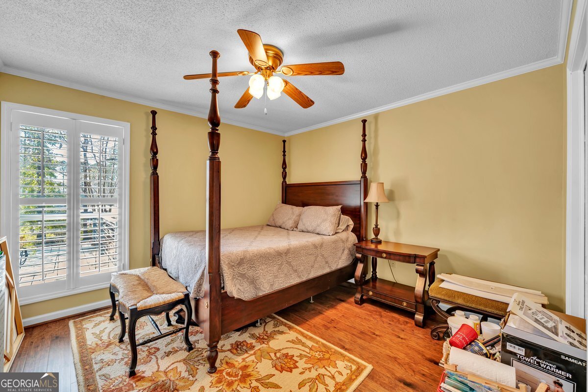 254 Valhalla Road South, Unit F Cordele, GA 31015 - Photo 24 of 41 a bedroom with a bed and wooden floor