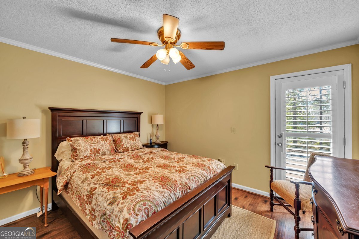 254 Valhalla Road South, Unit F Cordele, GA 31015 - Photo 27 of 41 a bedroom with a bed and a chandelier