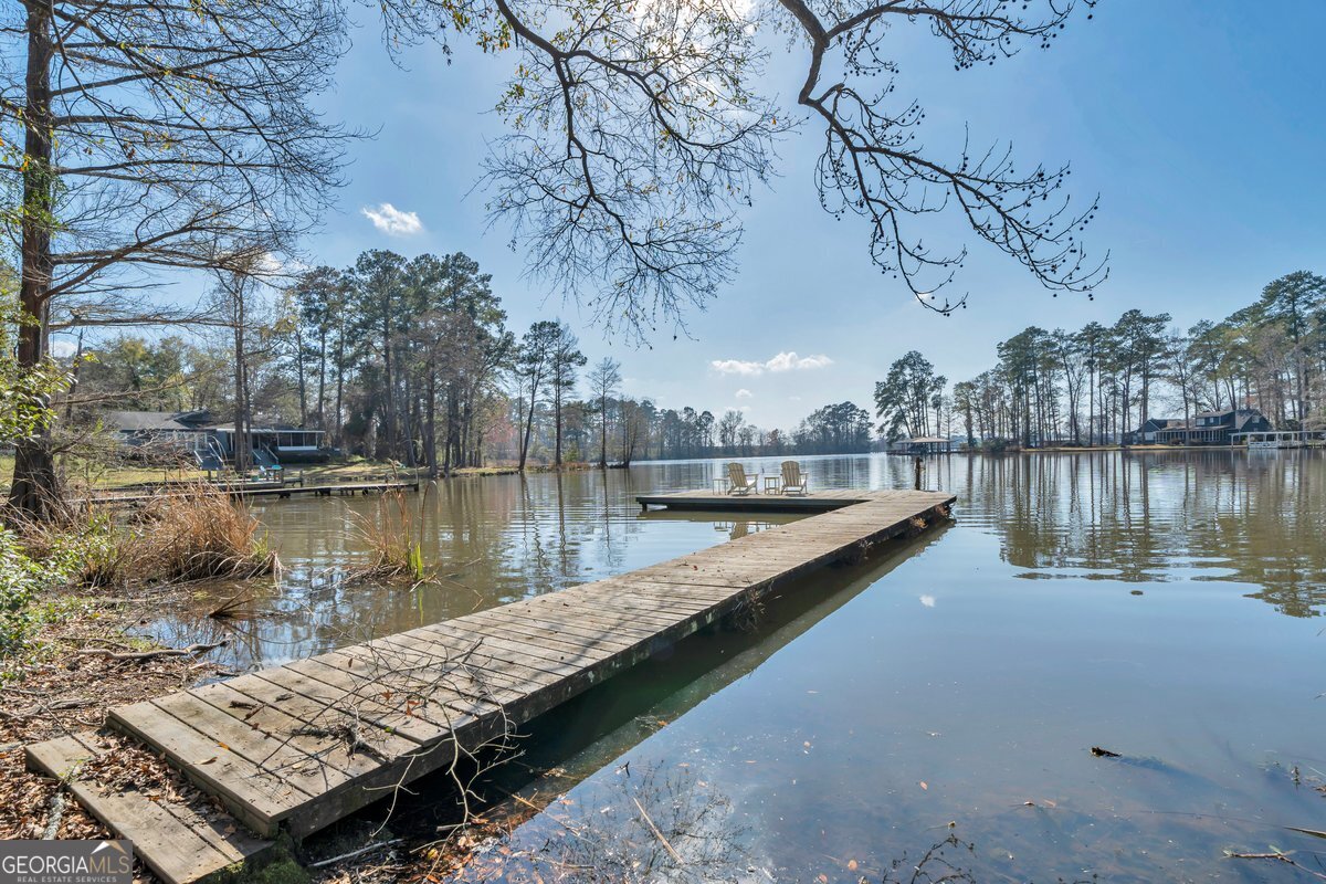 254 Valhalla Road South, Unit F Cordele, GA 31015 - Photo 4 of 41 a view of a lake with a bench next to a lake