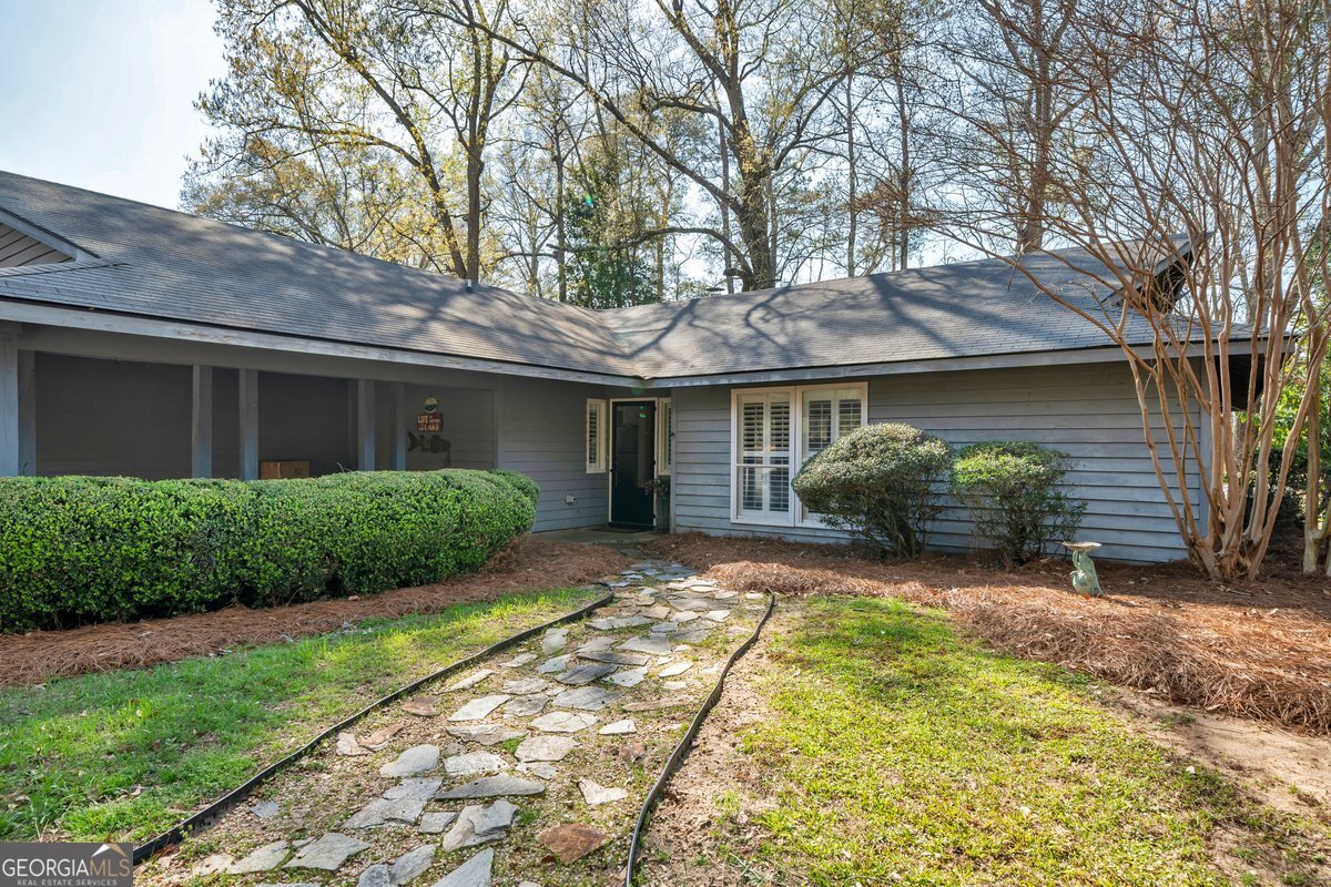 254 Valhalla Road South, Unit F Cordele, GA 31015 - Photo 6 of 41 a front view of a house with a garden and plants