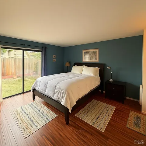 a bedroom with a bed and a large window