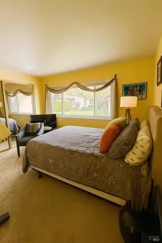 a bedroom with a bed and a night stand