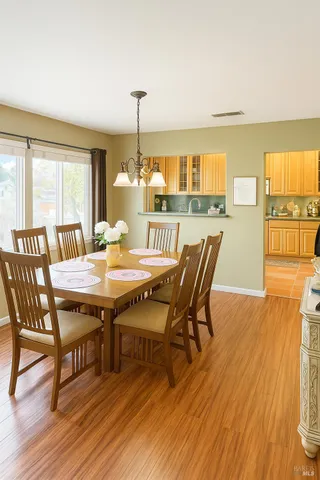 a dining room with furniture and wooden floor