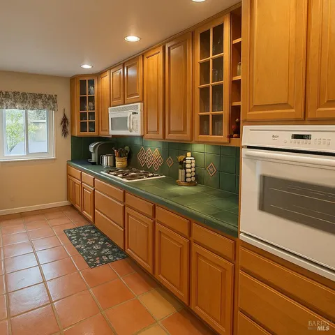a kitchen with stainless steel appliances a sink stove and cabinets