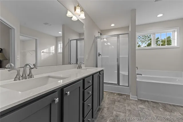 a bathroom with a granite countertop sink a large mirror and a bathtub