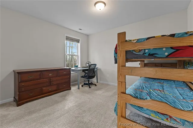 a bed room with a bed and a chair