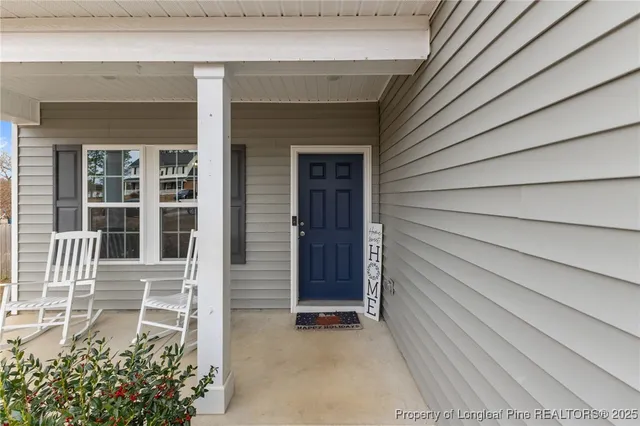 a view of a house with a door and wooden walls