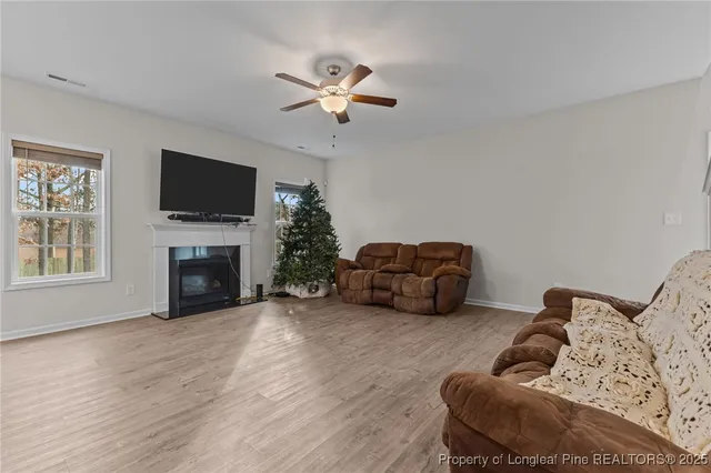 a living room with furniture a fireplace and a flat screen tv