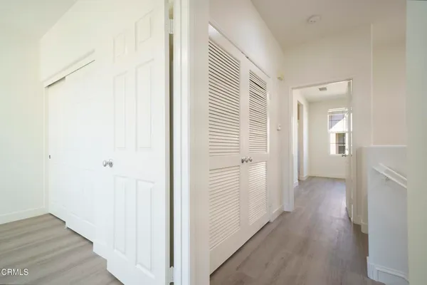 a view of a hallway with wooden floor