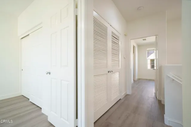 a view of a hallway with wooden floor