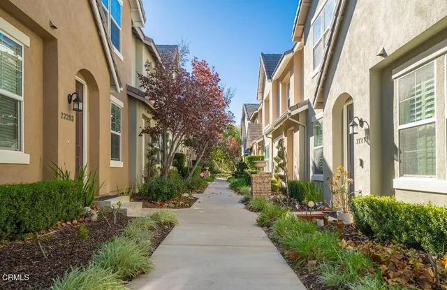 a view of a pathway both side of the house