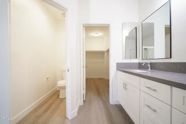a bathroom with a sink and mirror with toilet