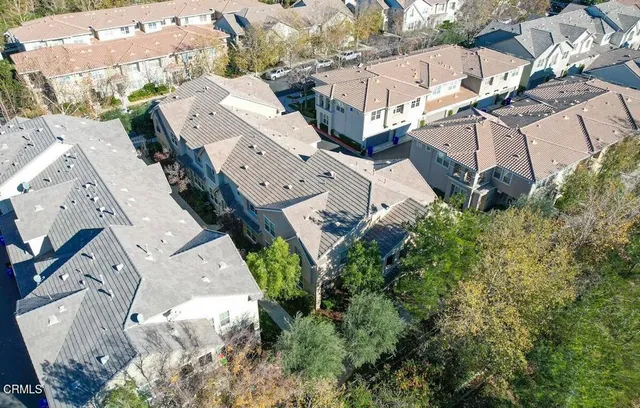an aerial view of multiple houses with yard