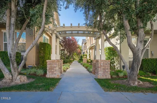 a view of a pathway of a house with a garden