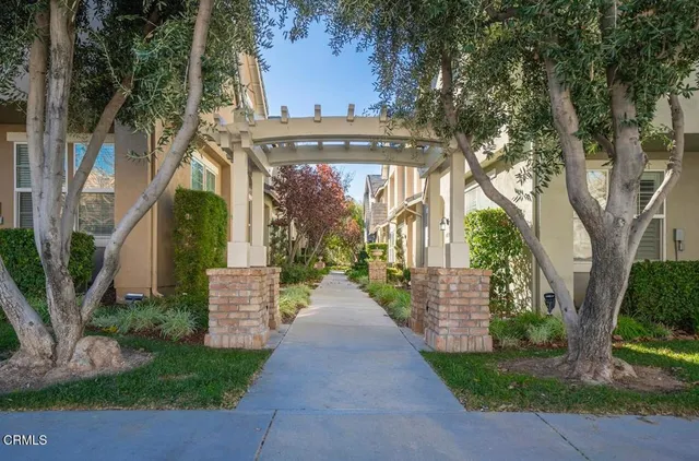 a view of a pathway of a house with a garden
