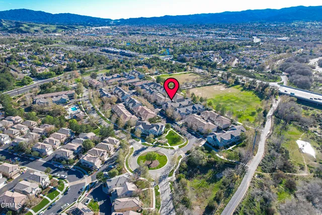 an aerial view of residential houses with outdoor space