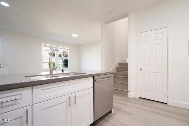 a kitchen with granite countertop cabinets and window