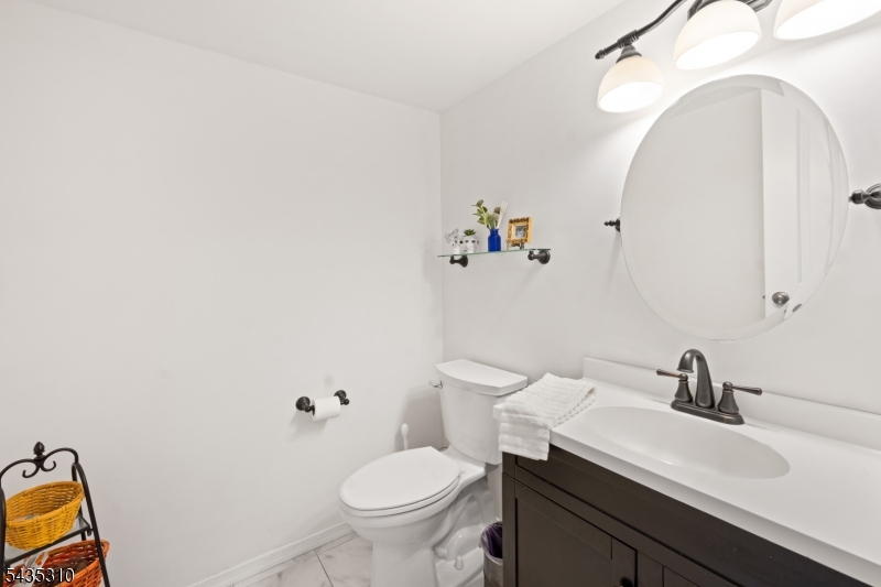 488 Auten Road, Unit 2D Hillsborough, NJ 08844 - Photo 13 of 30 a bathroom with a sink mirror and toilet