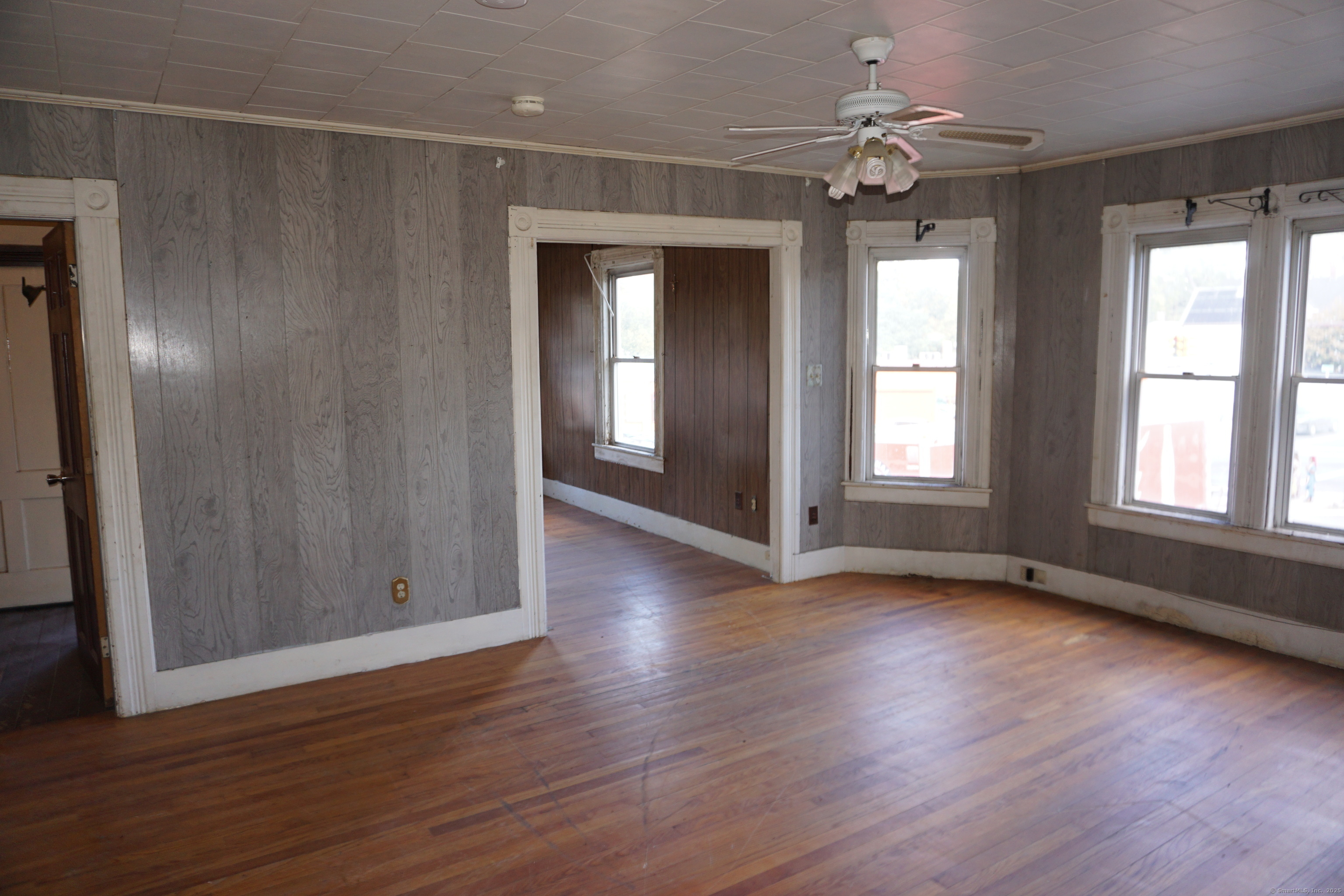 327 Orange Street Springfield, MA 01108 - Photo 18 of 32 an empty room with wooden floor and windows