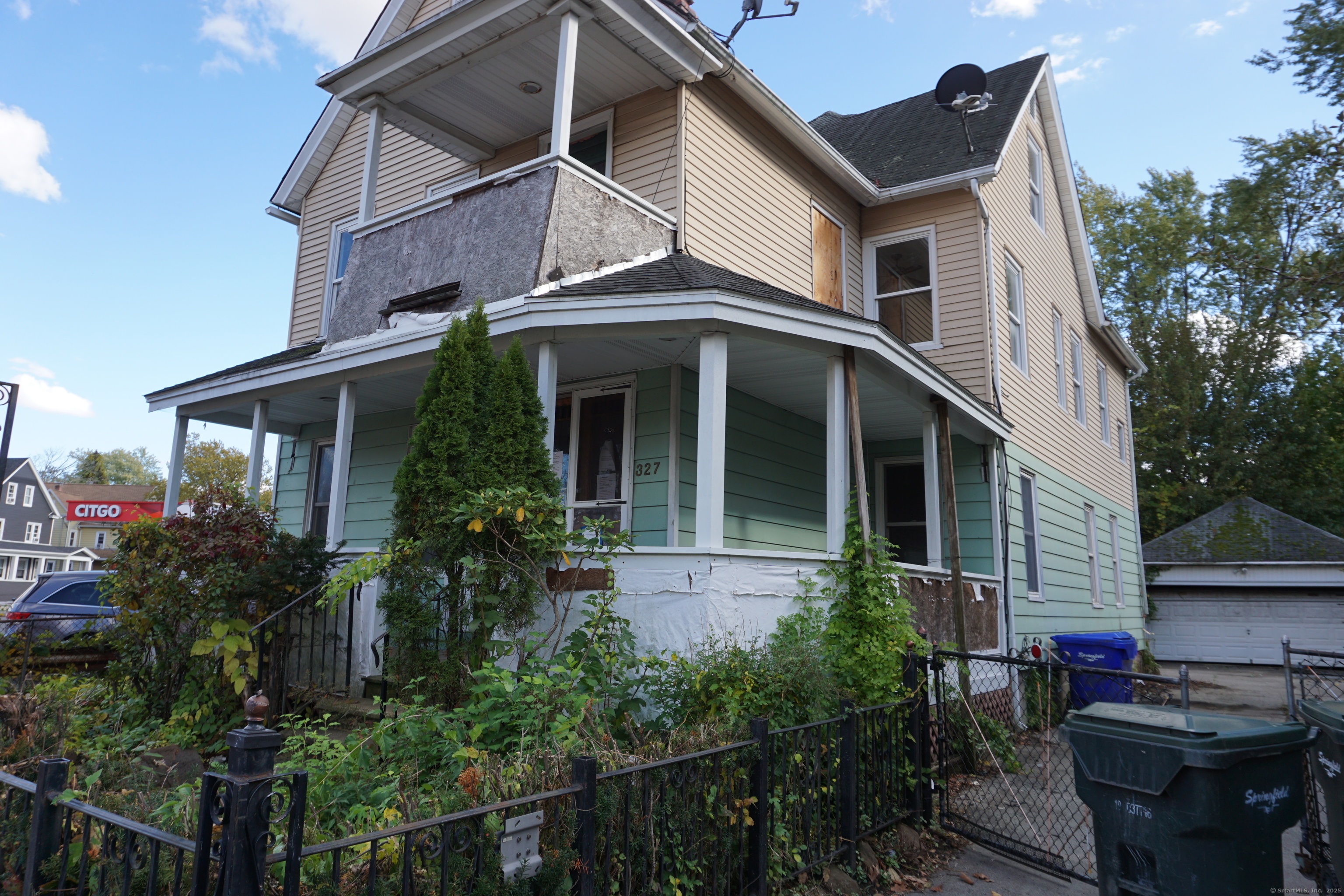 327 Orange Street Springfield, MA 01108 - Photo 2 of 32 a view of a white house with many windows and plants