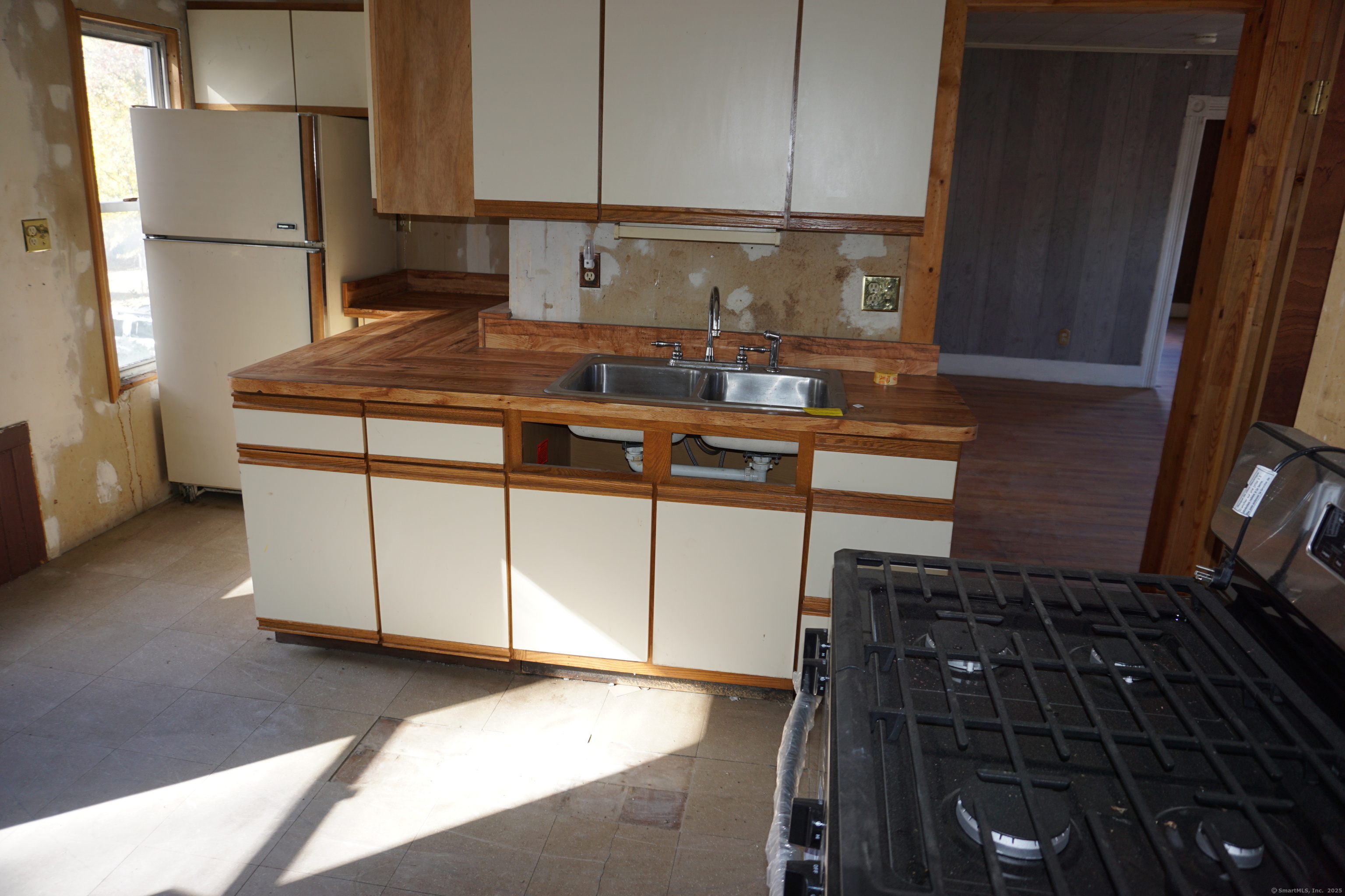 327 Orange Street Springfield, MA 01108 - Photo 22 of 32 a kitchen with kitchen island granite countertop a refrigerator a stove and a sink