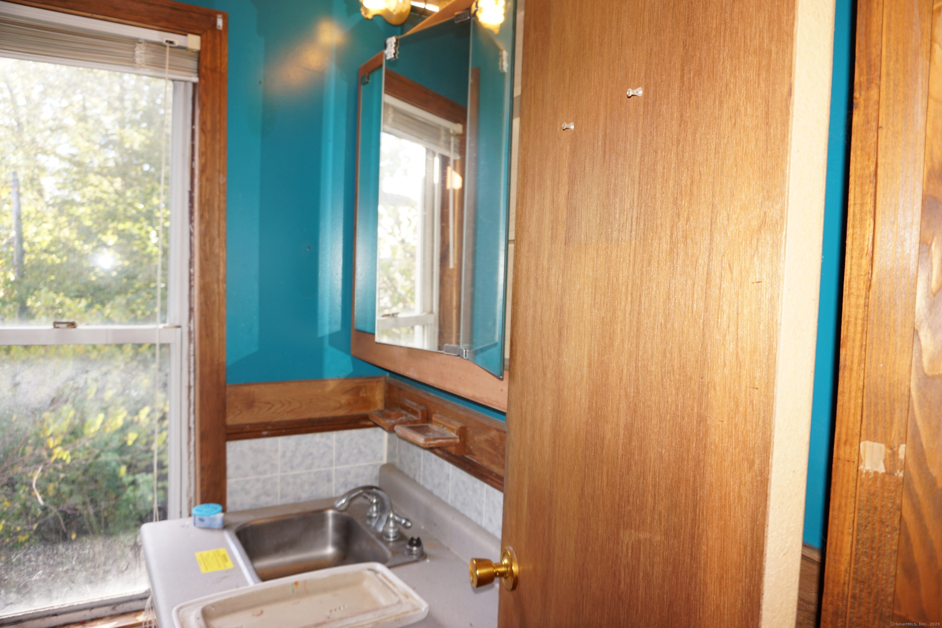 327 Orange Street Springfield, MA 01108 - Photo 24 of 32 a bathroom with a toilet sink and mirror