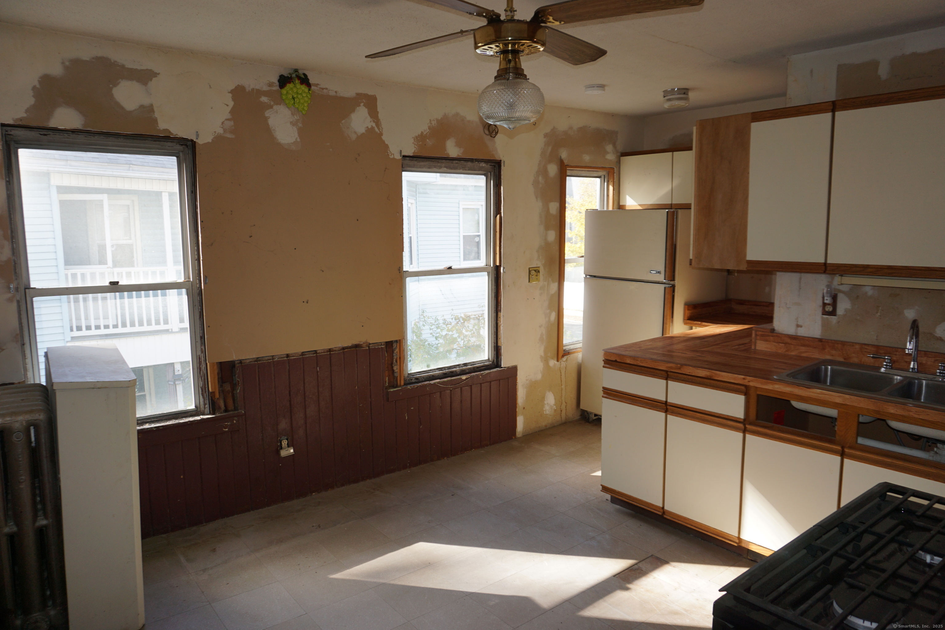 327 Orange Street Springfield, MA 01108 - Photo 27 of 32 a kitchen with stainless steel appliances granite countertop a stove a refrigerator and a microwave